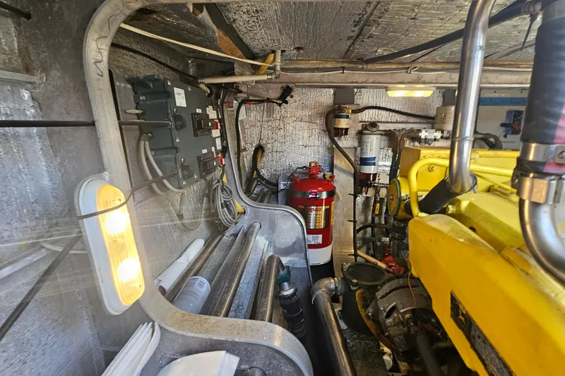 Nantucket Sleighride Yacht Photos Pics Engine room of 2005 Custom Sea Raider Catamaran with machinery and fire extinguisher.