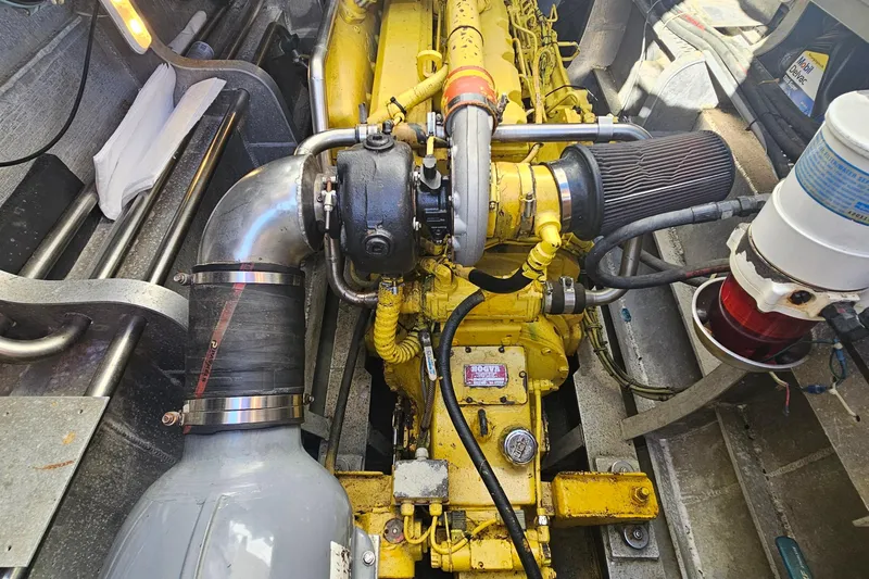 Nantucket Sleighride Yacht Photos Pics Engine compartment of a 2005 Custom Sea Raider Catamaran, featuring a yellow engine and components.