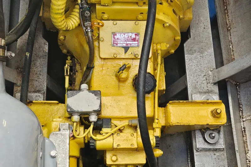 Nantucket Sleighride Yacht Photos Pics Engine compartment of a 2005 Custom Sea Raider Catamaran, featuring yellow machinery and hoses.