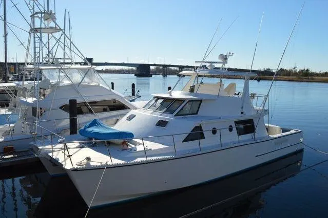Nantucket Sleighride Yacht Photos Pics 2005 Custom Sea Raider Catamaran docked at marina under clear blue sky.