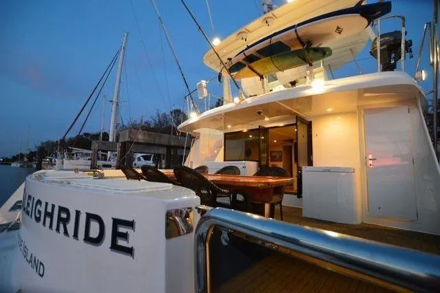 Nantucket Sleighride Yacht Photos Pics Custom 2005 Sea Raider Catamaran docked at sunset, featuring outdoor seating and modern amenities.