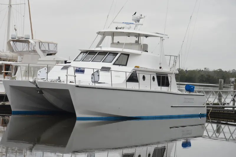 Nantucket Sleighride Yacht Photos Pics Custom 2005 Sea Raider Catamaran docked at marina, reflecting on calm water.