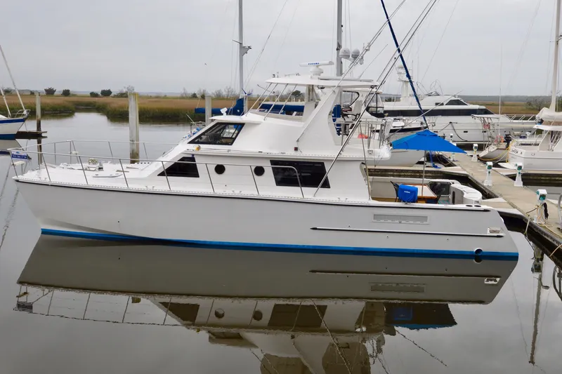Nantucket Sleighride Yacht Photos Pics Custom 2005 Sea Raider Catamaran docked at marina, reflecting on calm water.