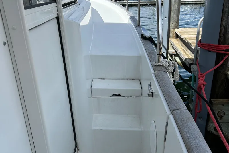 Tryst Yacht Photos Pics Side deck of 2006 Beneteau 42 Swift Trawler at dock, showing steps and railing.