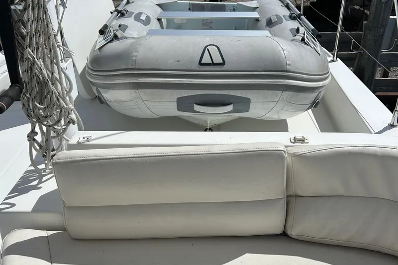 Tryst Yacht Photos Pics 2006 Beneteau 42 Swift Trawler with inflatable dinghy on deck, white seating visible.