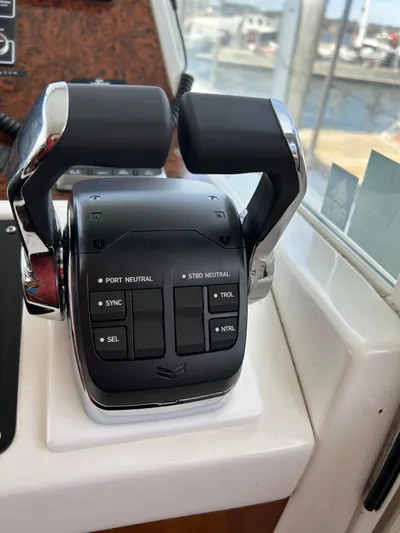 Tryst Yacht Photos Pics Throttle controls on a 2006 Beneteau 42 Swift Trawler, featuring dual levers and control buttons.