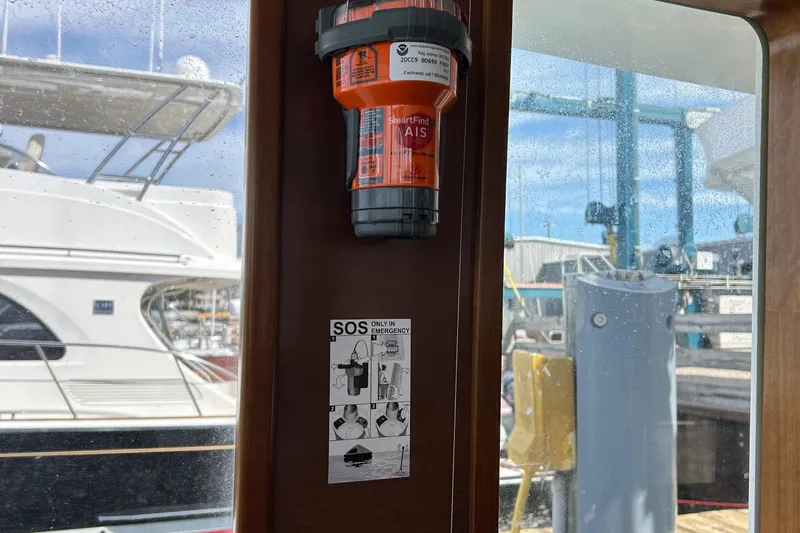 Tryst Yacht Photos Pics Orange emergency beacon and SOS instructions on a 2006 Beneteau 42 Swift Trawler.