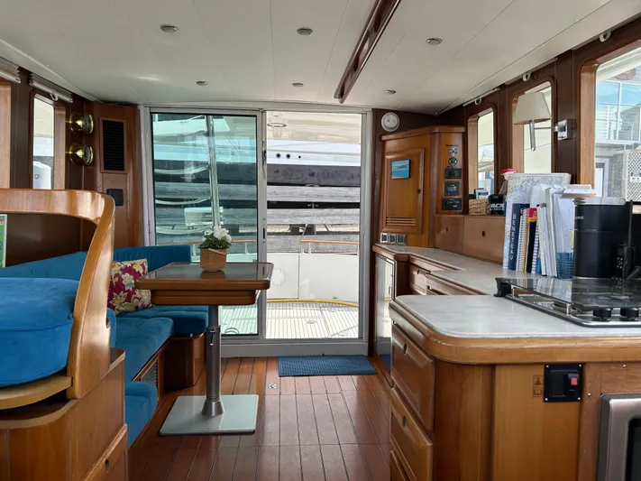 Tryst Yacht Photos Pics Interior of 2006 Beneteau 42 Swift Trawler with wood finish and blue seating.