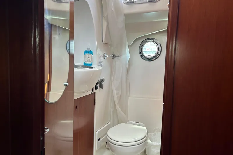 Tryst Yacht Photos Pics Bathroom interior of 2006 Beneteau 42 Swift Trawler with porthole and sink.