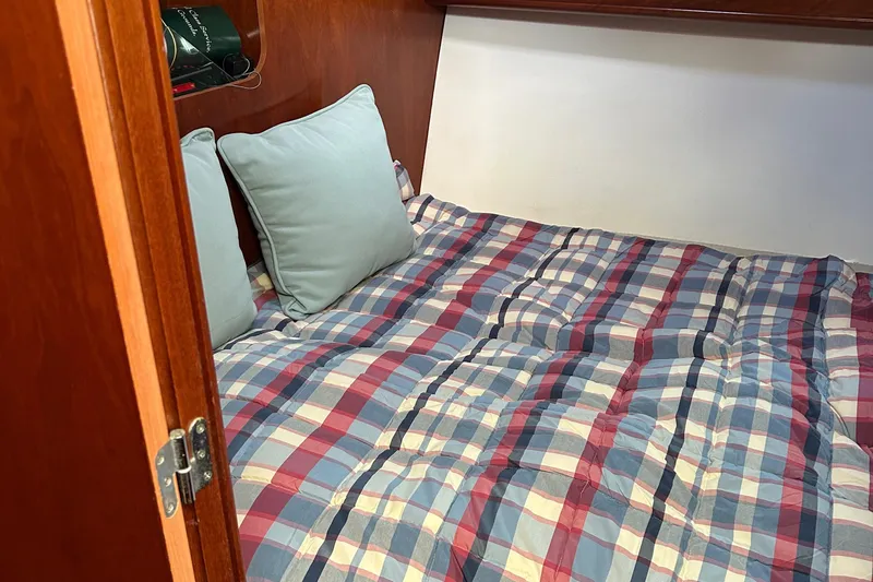 Tryst Yacht Photos Pics Cozy cabin bed with plaid bedding in 2006 Beneteau 42 Swift Trawler.