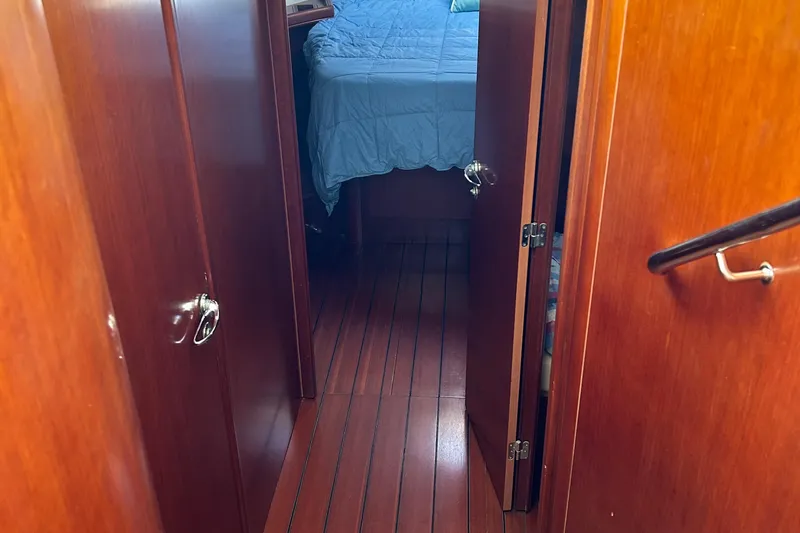 Tryst Yacht Photos Pics Interior hallway of 2006 Beneteau 42 Swift Trawler with wood paneling and visible bedroom.