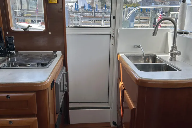 Tryst Yacht Photos Pics Interior of 2006 Beneteau 42 Swift Trawler kitchen with sink and stove.