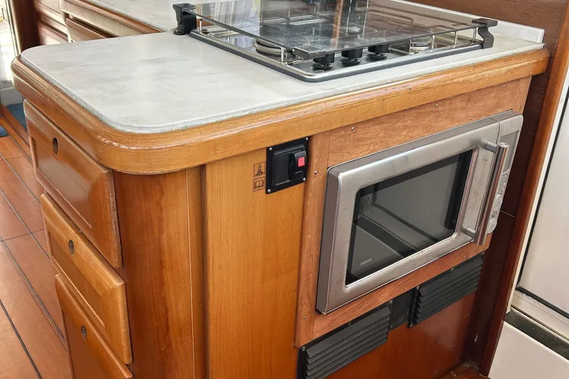 Tryst Yacht Photos Pics Kitchen area of 2006 Beneteau 42 Swift Trawler with microwave and stove.