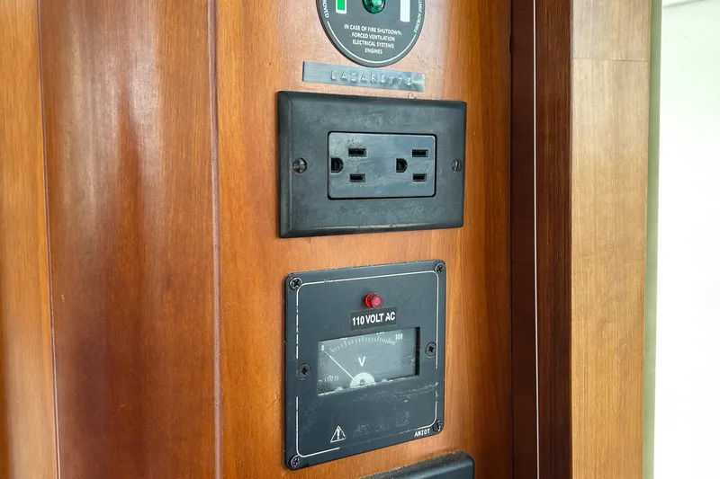 Tryst Yacht Photos Pics Electrical outlet and voltage meter on 2006 Beneteau 42 Swift Trawler wooden panel.