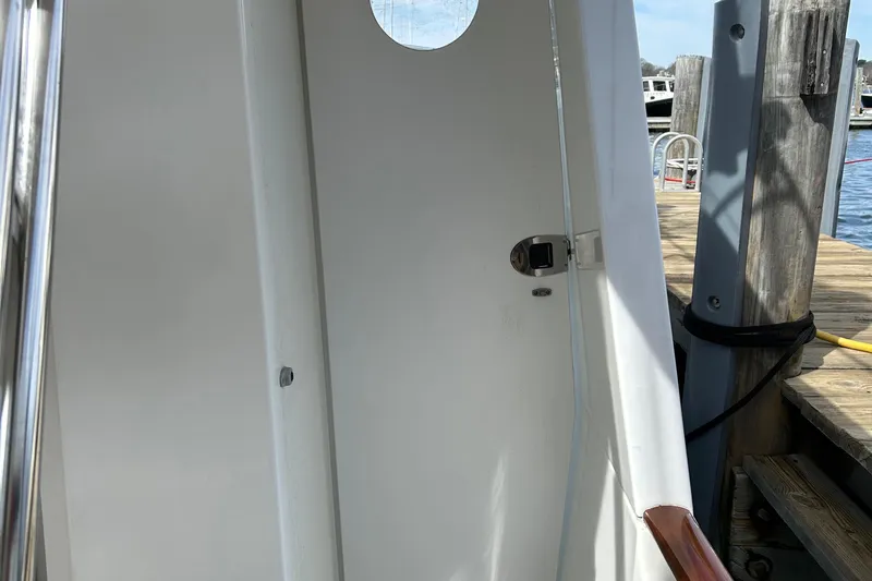 Tryst Yacht Photos Pics Beneteau 42 Swift Trawler 2006, white exterior with porthole, docked at marina.