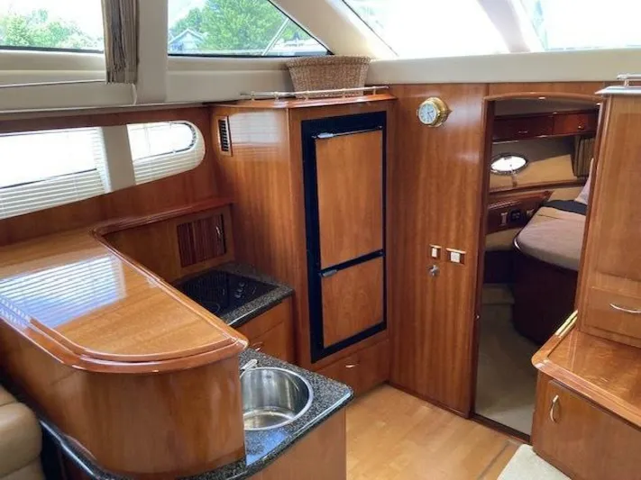 Second Knot Yacht Photos Pics Interior of 2003 Carver 396 Aft Cabin MY yacht with wood finish and kitchenette.