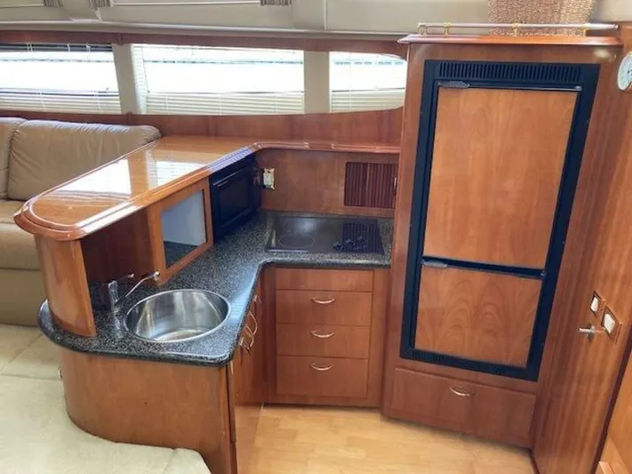 Second Knot Yacht Photos Pics 2003 Carver 396 Aft Cabin MY yacht interior with kitchenette, featuring wood cabinetry and modern appliances.