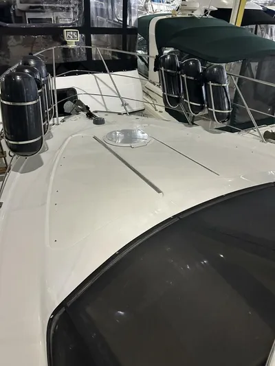 Second Knot Yacht Photos Pics 2003 Carver 396 Aft Cabin MY yacht deck with fenders and railing.