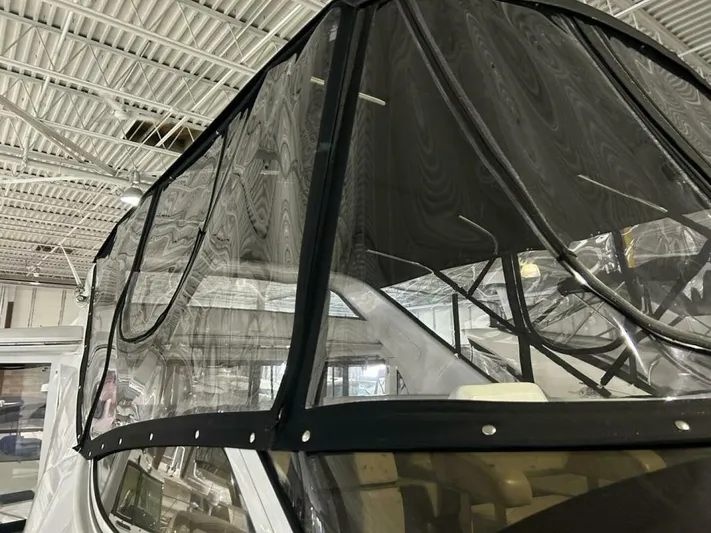 Second Knot Yacht Photos Pics 2003 Carver 396 Aft Cabin MY with black canvas enclosure in a warehouse setting.