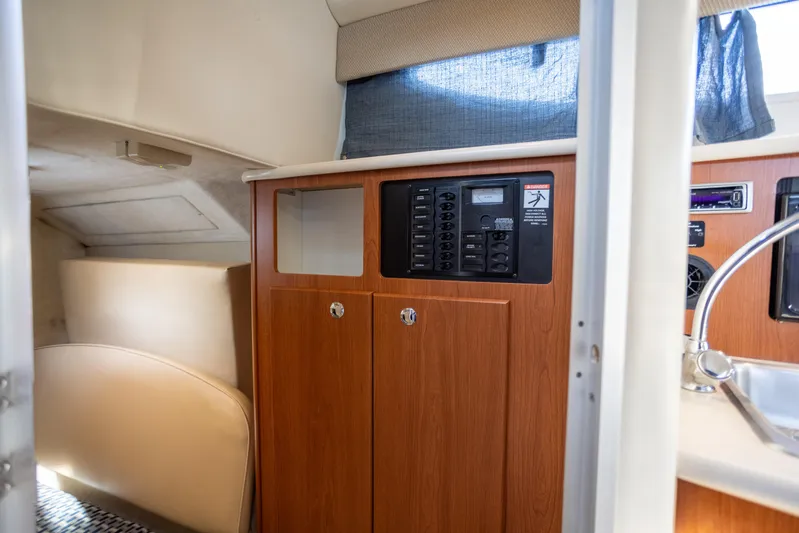 No Name - Our Trade Yacht Photos Pics Interior of 2005 Bayliner 285 boat with control panel and seating area.