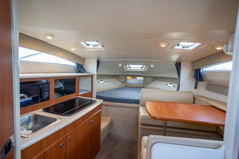 No Name - Our Trade Yacht Photos Pics Interior of 2005 Bayliner 285 boat with kitchenette, dining area, and sleeping quarters.