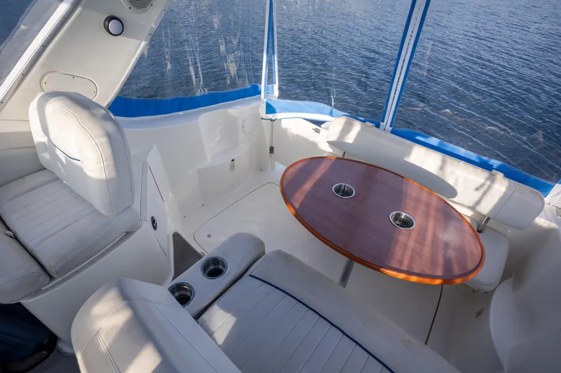 No Name - Our Trade Yacht Photos Pics Interior of 2005 Bayliner 285 boat with seating and table, overlooking water.