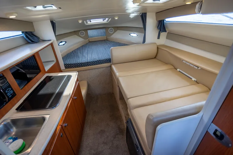 No Name - Our Trade Yacht Photos Pics 2005 Bayliner 285 interior with kitchenette, seating, and sleeping area.