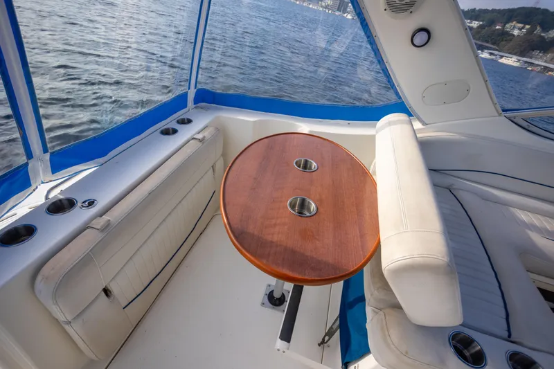No Name - Our Trade Yacht Photos Pics 2005 Bayliner 285 boat interior with round wooden table and white seating.
