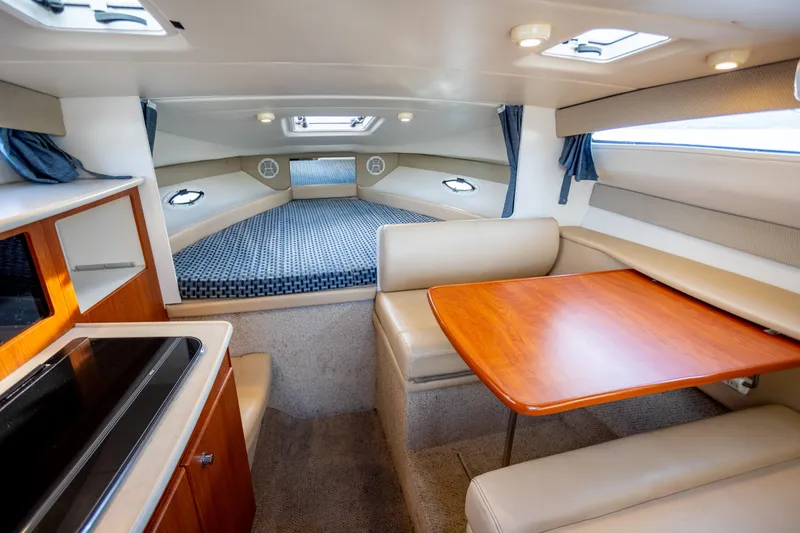 No Name - Our Trade Yacht Photos Pics Interior of 2005 Bayliner 285 boat with dining area and sleeping quarters.