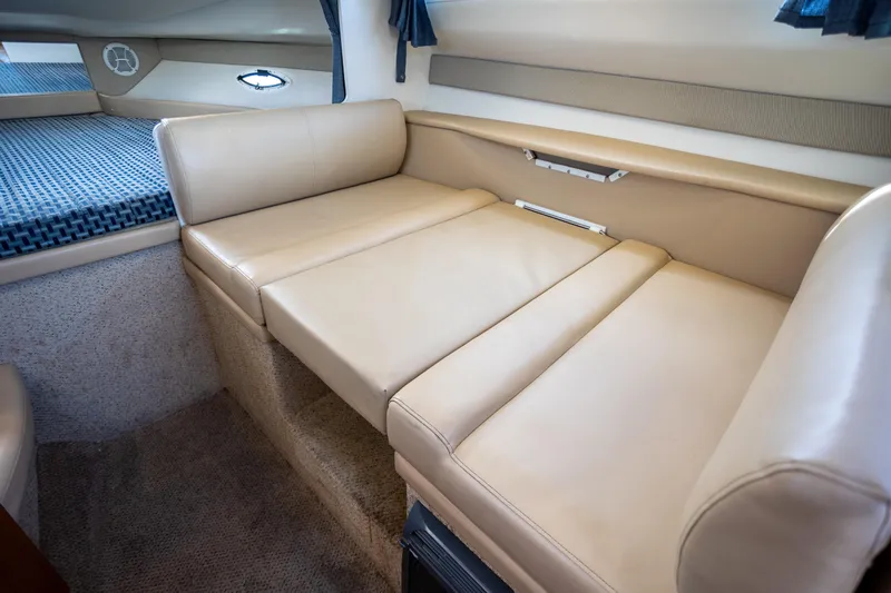 No Name - Our Trade Yacht Photos Pics Interior of 2005 Bayliner 285 boat with beige leather seating and cozy cabin space.