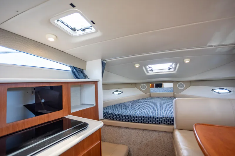 No Name - Our Trade Yacht Photos Pics Luxurious interior of 2005 Bayliner 285 boat with cozy sleeping area and modern amenities.