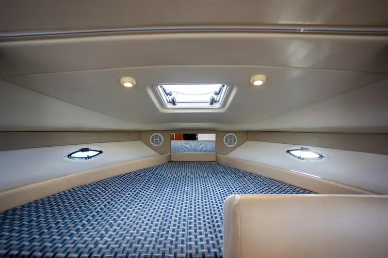 No Name - Our Trade Yacht Photos Pics Interior cabin of 2005 Bayliner 285 boat with patterned flooring and ceiling lights.