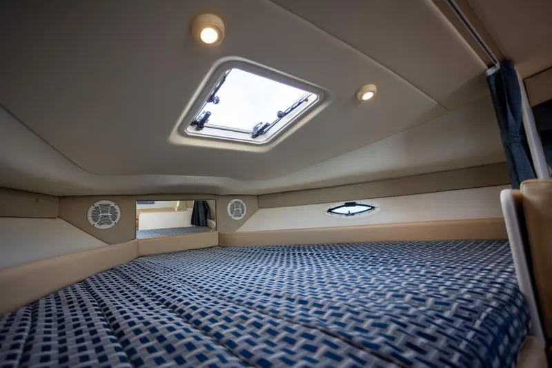 No Name - Our Trade Yacht Photos Pics Interior cabin of 2005 Bayliner 285 boat with skylight and patterned bedding.
