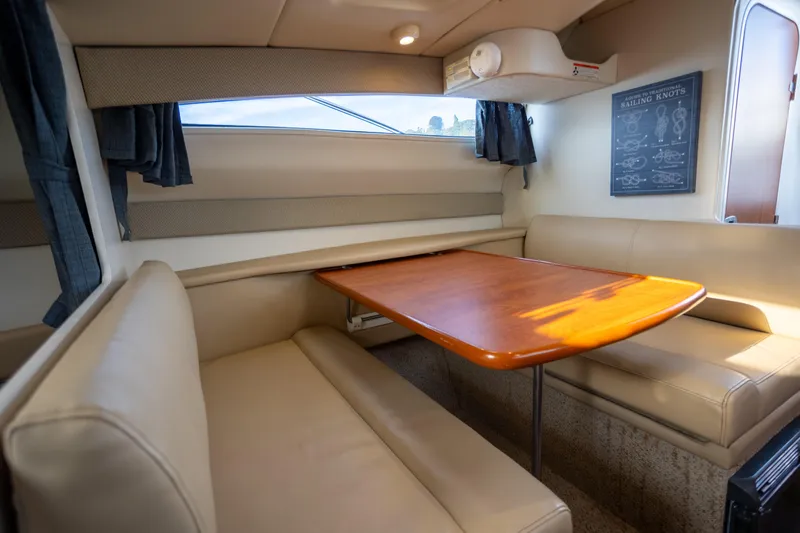 No Name - Our Trade Yacht Photos Pics Interior of 2005 Bayliner 285 boat with cozy dining area and nautical decor.