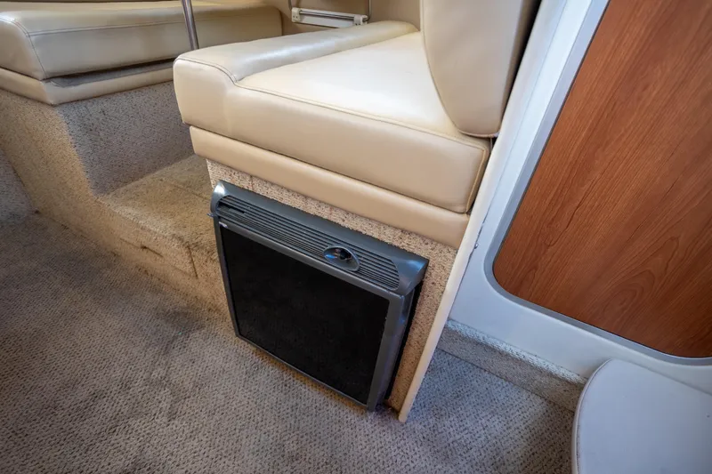 No Name - Our Trade Yacht Photos Pics Interior of 2005 Bayliner 285 boat with beige seating and compact fridge.