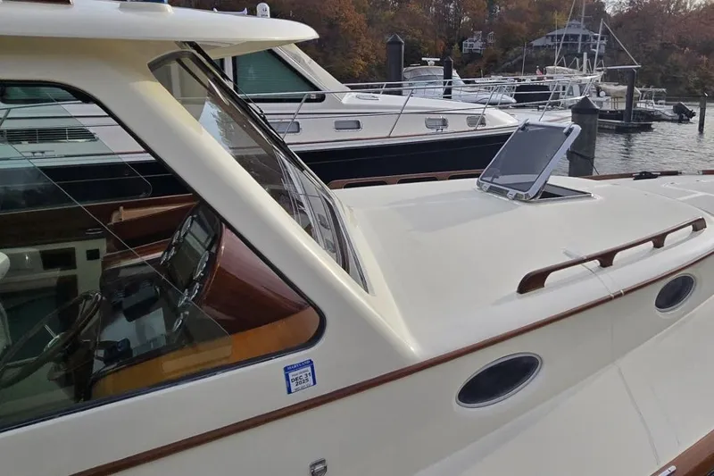 Dragonfly Yacht Photos Pics 2009 Hinckley 37 yacht docked, showcasing sleek design and elegant wood accents.