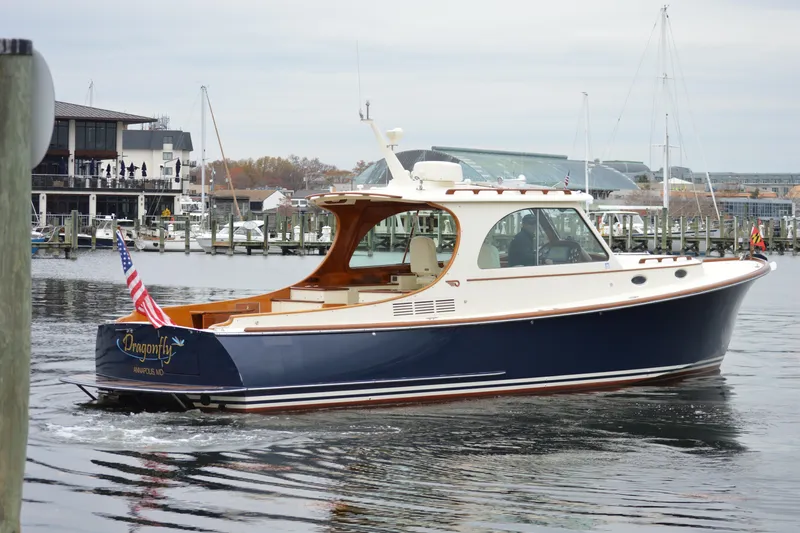 Dragonfly Yacht Photos Pics 2009 Hinckley 37 yacht, "Dragonfly," cruising in a marina with American flag.