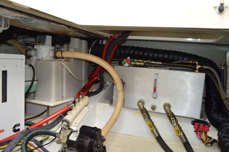 Dragonfly Yacht Photos Pics Engine compartment of a 2009 Hinckley 37 boat, showcasing hoses and mechanical components.