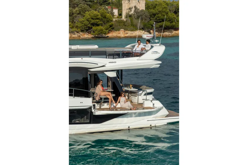  Yacht Photos Pics 2026 Galeon 480 Fly yacht cruising with passengers, scenic coastal backdrop.