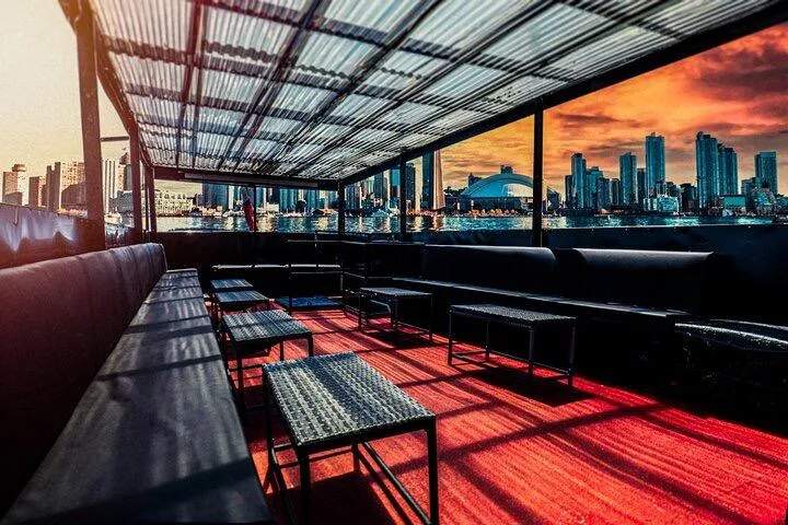 Island Princess Yacht Photos Pics Rooftop seating on 1983 Custom Steel Passenger boat with city skyline at sunset.