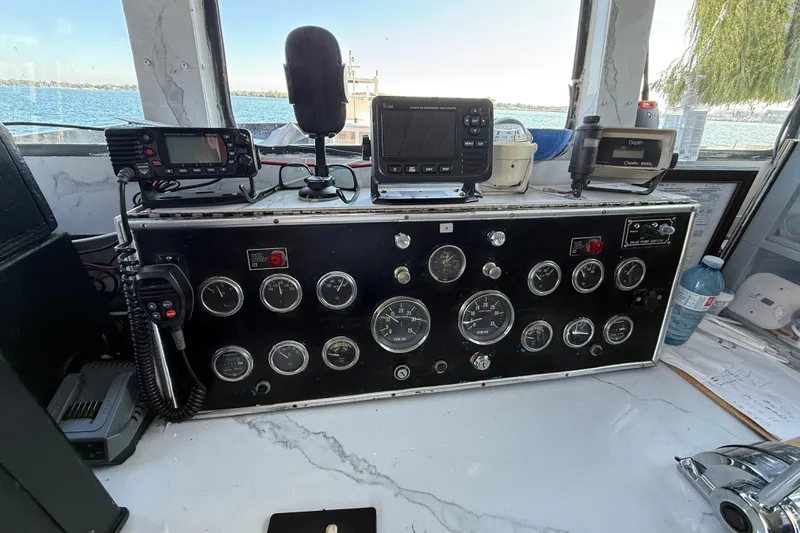 Island Princess Yacht Photos Pics Control panel of a 1983 Custom Steel Passenger boat, featuring gauges and navigation equipment.