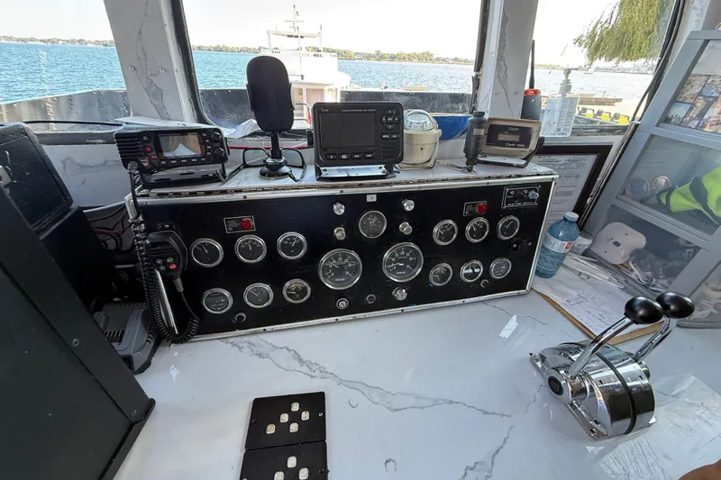 Island Princess Yacht Photos Pics Control panel of a 1983 Custom Steel Passenger boat, featuring gauges and navigation equipment.
