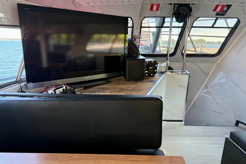 Island Princess Yacht Photos Pics Interior of 1983 Custom Steel Passenger boat with TV and seating area.