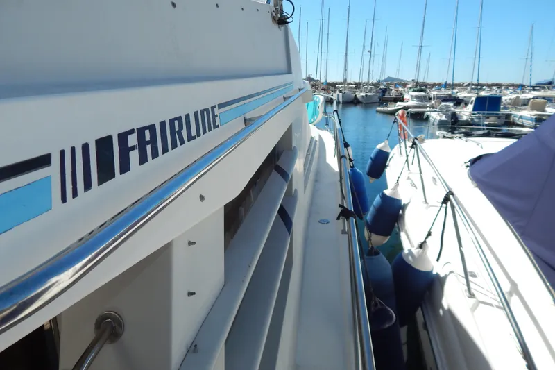  Yacht Photos Pics 1992 Fairline 50 yacht docked in a marina, surrounded by other boats.