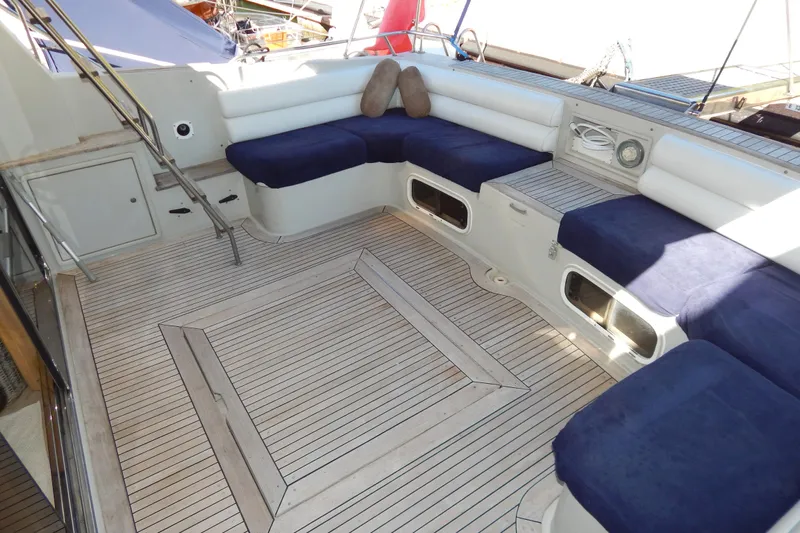  Yacht Photos Pics Spacious deck seating on 1992 Fairline 50 yacht with blue cushions and wooden flooring.