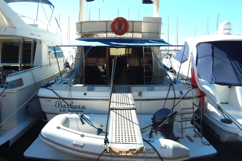  Yacht Photos Pics 1992 Fairline 50 yacht docked with inflatable boat and canopy.