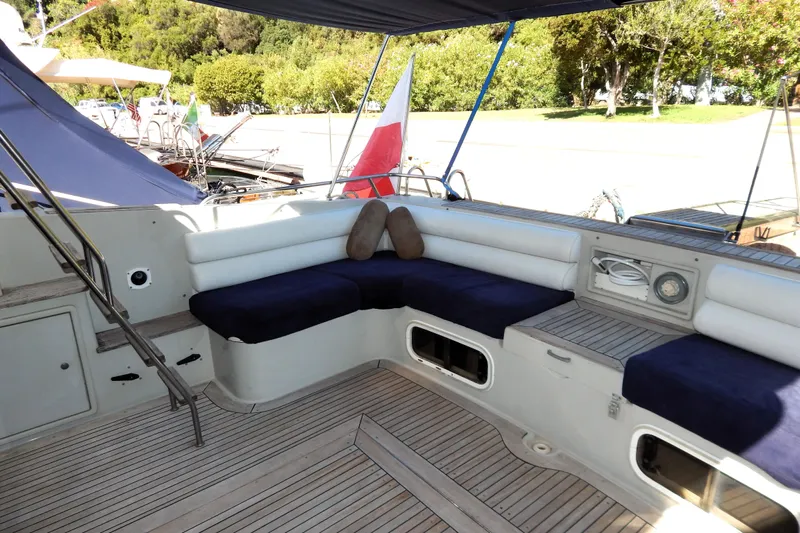  Yacht Photos Pics Spacious deck seating on 1992 Fairline 50 yacht with navy cushions and white accents.