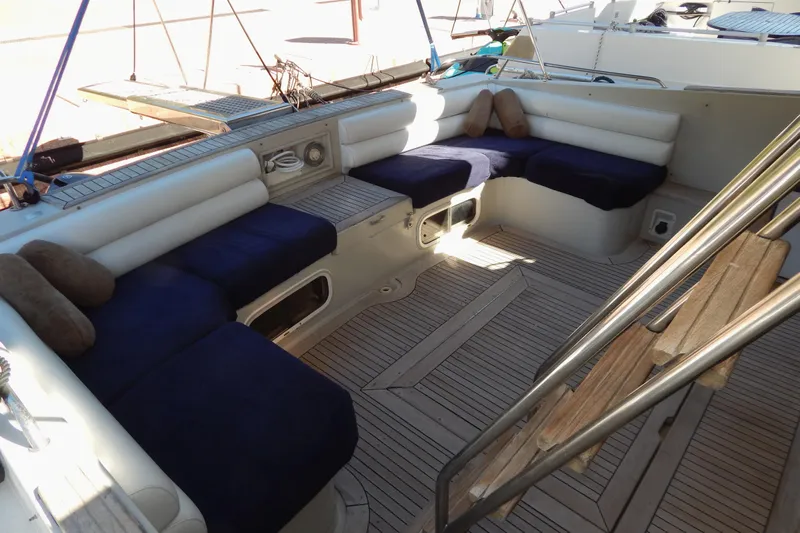  Yacht Photos Pics 1992 Fairline 50 yacht interior with blue cushioned seating and wooden flooring.