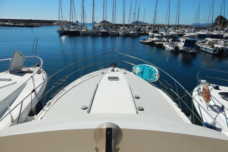  Yacht Photos Pics Bow view of 1992 Fairline 50 yacht docked in a marina with sailboats.