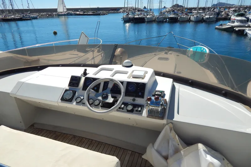  Yacht Photos Pics Cockpit view of 1992 Fairline 50 yacht in marina with clear blue water.